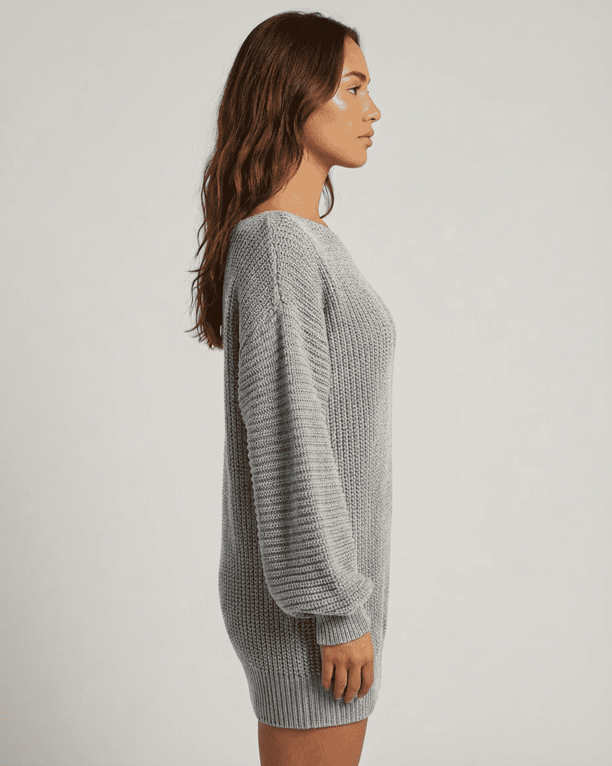 Selene Mini Dress by RAMBLION in grey ribbed knit with off-the-shoulder lantern sleeves styled in a side profile view.