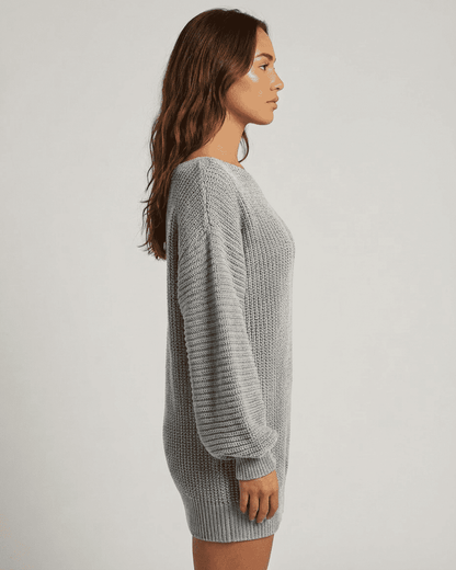 Selene Mini Dress by RAMBLION in grey ribbed knit with off-the-shoulder lantern sleeves styled in a side profile view.