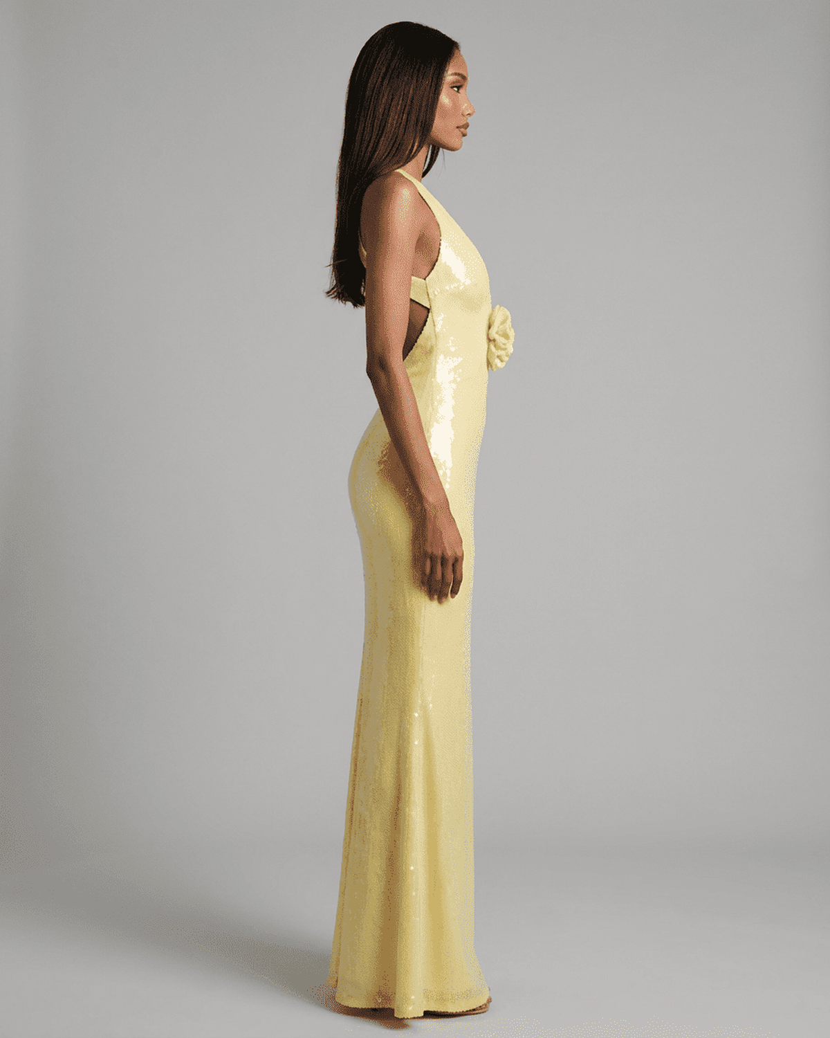 Solara Maxi Dress by RAMBLION in yellow with backless V-neck silhouette and floral sequin detail.
