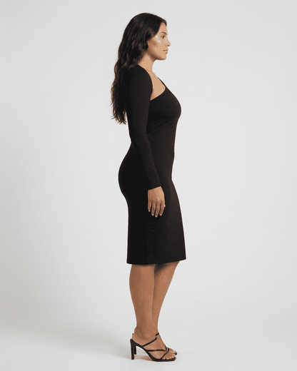 Vega Midi Dress by RAMBLION displayed on a model from the side showcasing its chic one-shoulder design and bodycon fit.