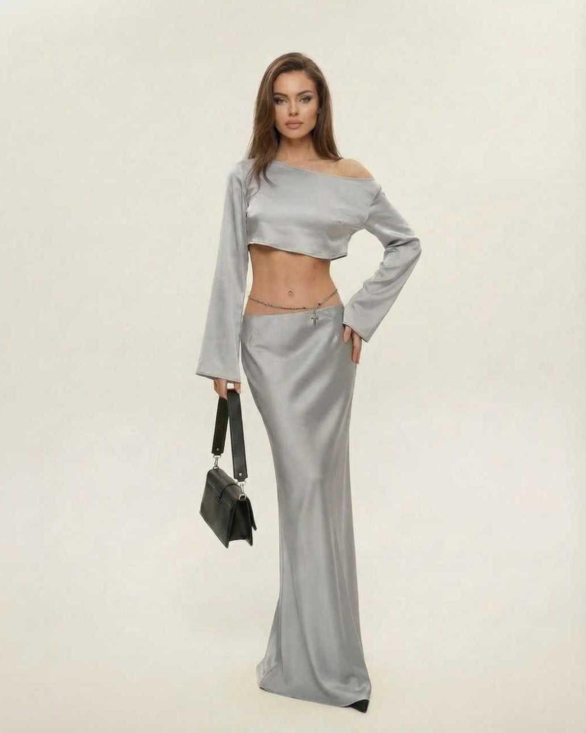 Lexa Midi Dress in grey satin, featuring a slash neckline and asymmetrical silhouette, perfect for elegant evening wear by RAMBLION.
