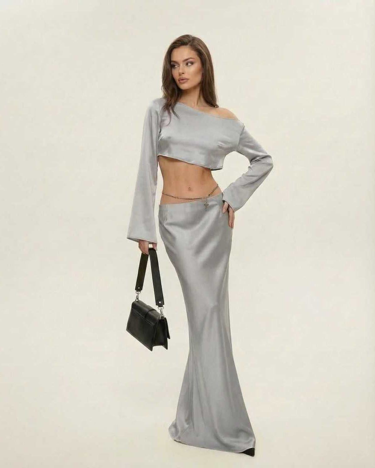 Model wearing Lexa Midi Dress in luxurious grey satin, featuring a slash neckline, perfect for elegant evening occasions.