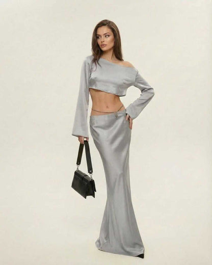 Model wearing Lexa Midi Dress in luxurious grey satin, featuring a slash neckline, perfect for elegant evening occasions.