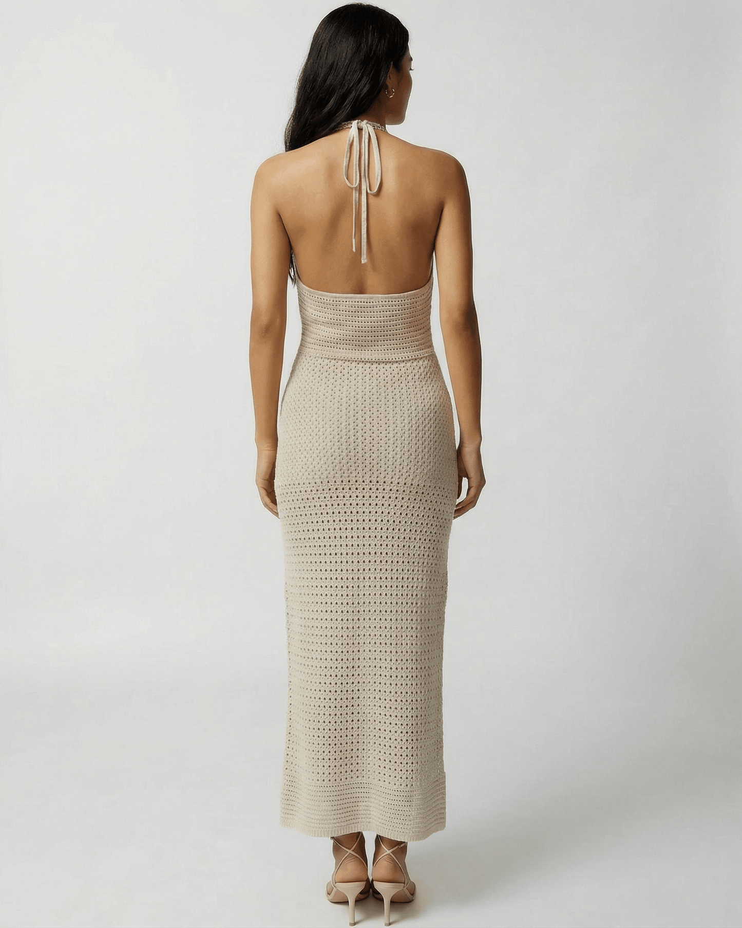 Back view of Lova Maxi Dress in beige with halter neck, perfect for warm weather outings - RAMBLION.
