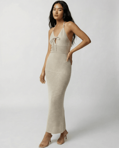 Lova Maxi Dress: Beige ankle-length, halter-neck design, perfect for warm weather, by RAMBLION.