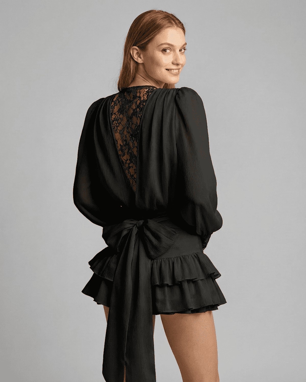 Misa Mini Dress by RAMBLION in black, V neck with lace accents, flowy tiered design, perfect for elegant occasions.