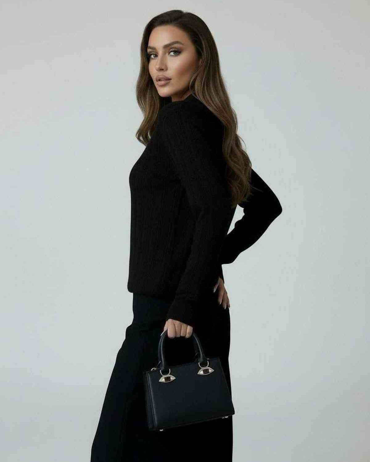 Model wearing the Monaco Sweater, a black knit sweater by RAMBLION, perfect for stylish fall looks.