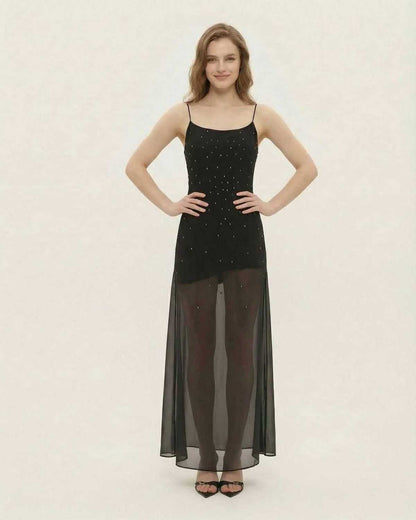Neva Maxi Dress featuring a black A-line silhouette with sheer mesh paneling and glitter accents, perfect for elegant evenings.