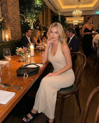 Nira Maxi Dress in a stylish setting, showcasing its elegant V neck design, perfect for sophisticated dining occasions.