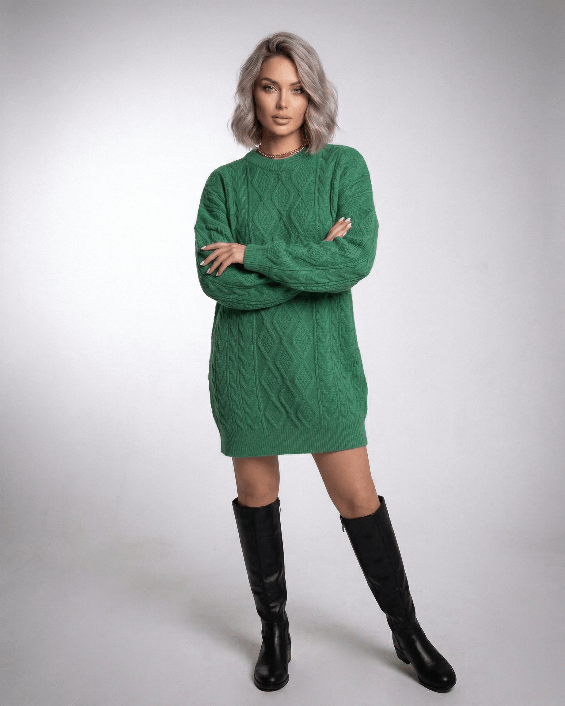 Model wearing a stylish Nova Mini Dress in emerald green, showcasing its cable knit texture and relaxed elegance for casual outings.