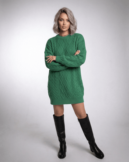Model wearing a stylish Nova Mini Dress in emerald green, showcasing its cable knit texture and relaxed elegance for casual outings.