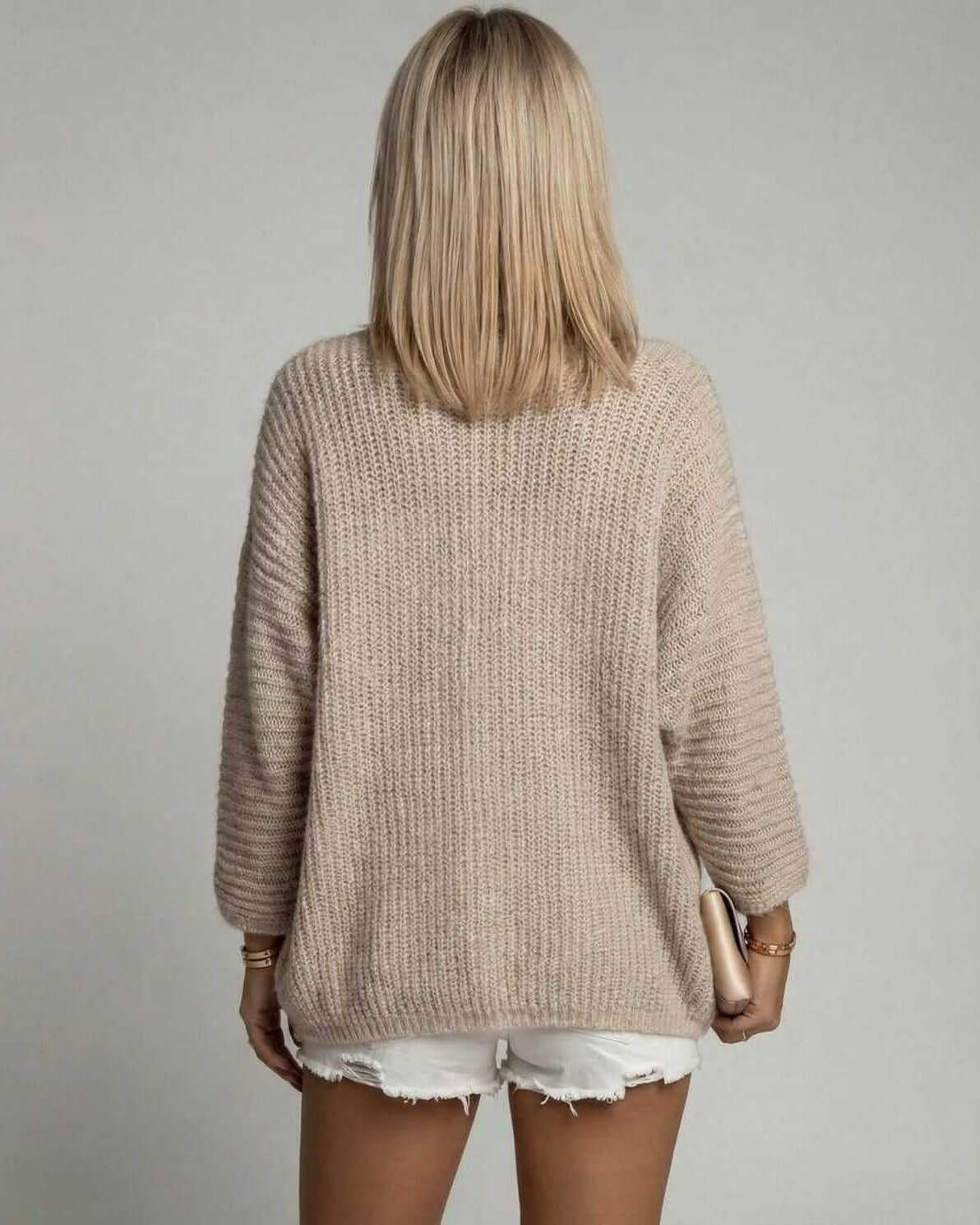 Back view of Obia Cardigan in soft beige, a cozy women's sweater perfect for layering this autumn, by RAMBLION.