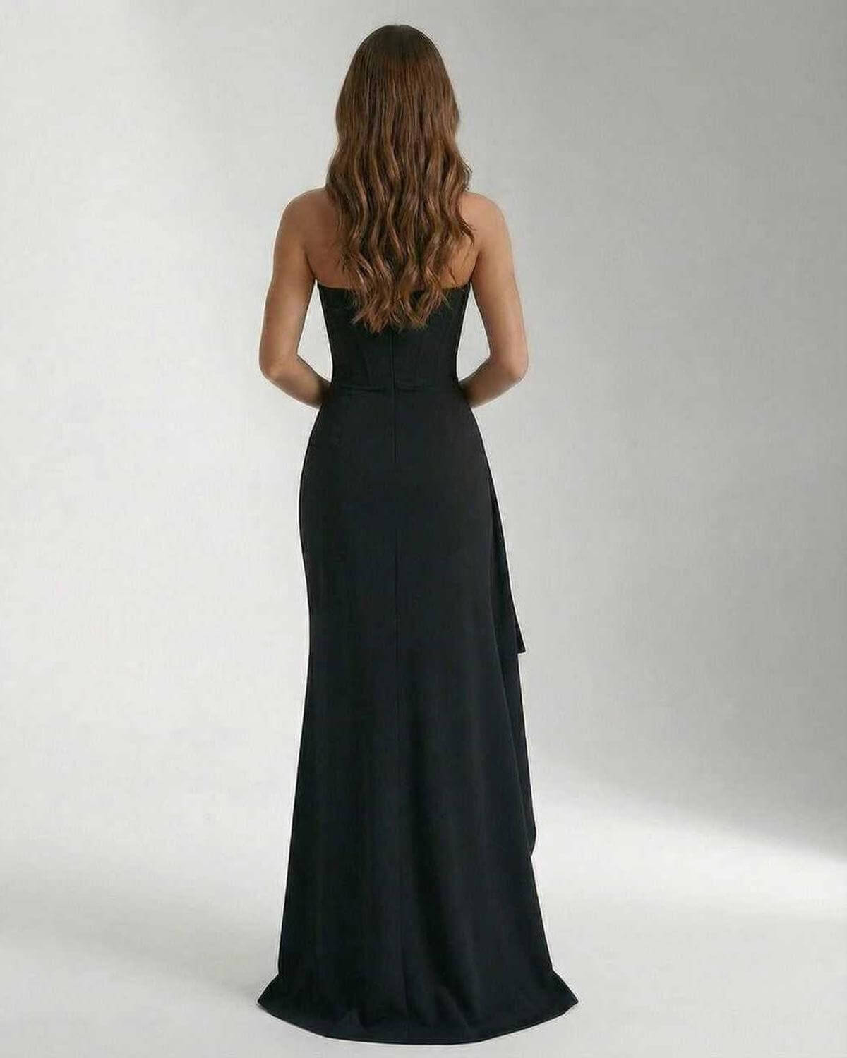Back view of the Olma Maxi Dress, a black ankle-length gown by RAMBLION. Elegant, strapless with a flowing silhouette.