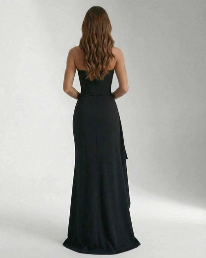 Back view of the Olma Maxi Dress, a black ankle-length gown by RAMBLION. Elegant, strapless with a flowing silhouette.