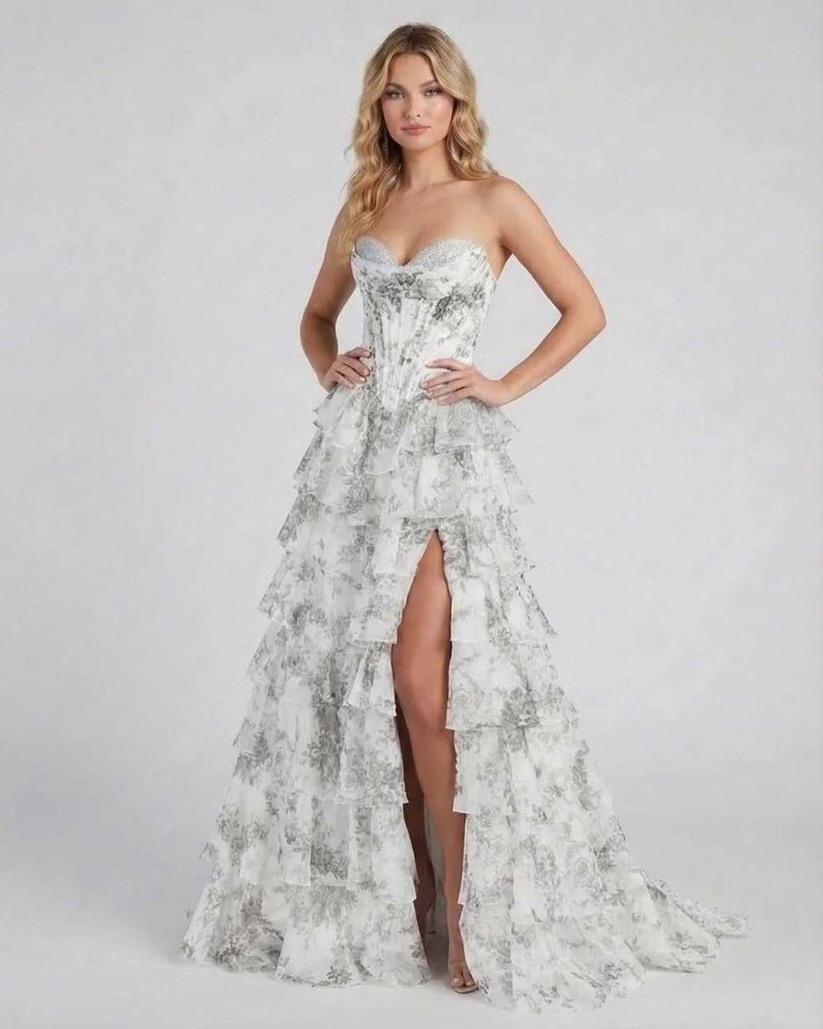 Ora Maxi Dress by RAMBLION in silver satin, featuring tiered ruffles and high slit for elegant occasions.