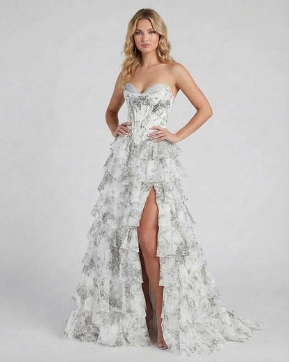 Ora Maxi Dress by RAMBLION in silver satin, featuring tiered ruffles and high slit for elegant occasions.
