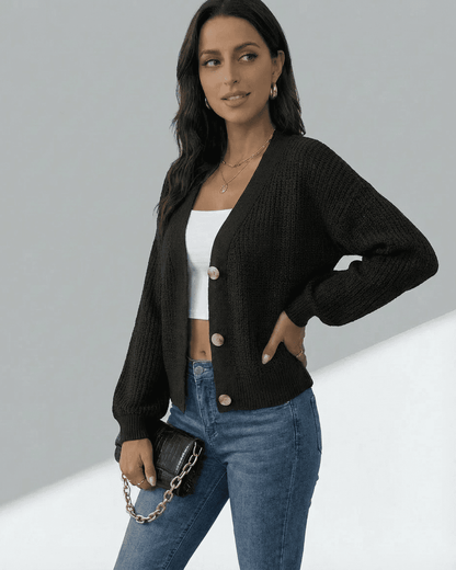 Model wearing an Orion Cardigan with a V-neckline, paired with a white tank and jeans, showcasing modern style.