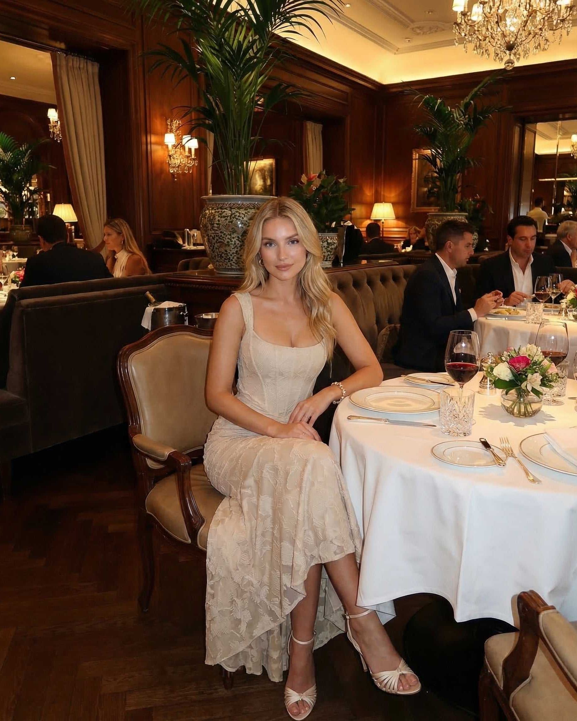 Ovra Maxi Dress at a dimly lit restaurant, showcasing elegance with a square neckline and romantic beige hue.