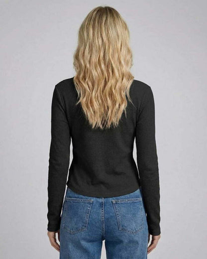 Back view of a woman in a black Positano Top, perfect blend of style and comfort for any occasion by RAMBLION.