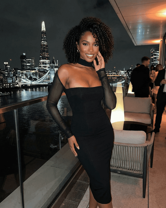 Stylish woman in a Reda Midi Dress featuring semi-sheer sleeves, perfect for upscale events, by RAMBLION.