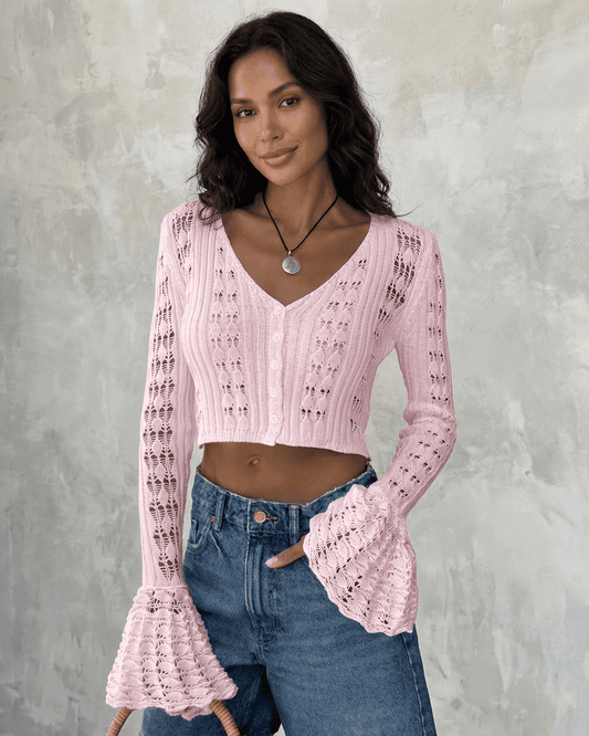 Model wearing the Blossom Cardigan in pink with flare sleeves, showcasing elegant cotton knit style.