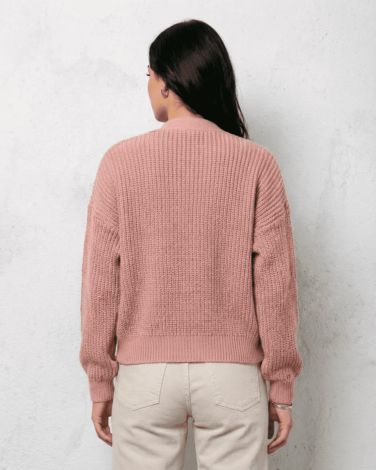 Back view of a Blush Cardigan in soft pink knitwear, showcasing relaxed fit and V-neck design.