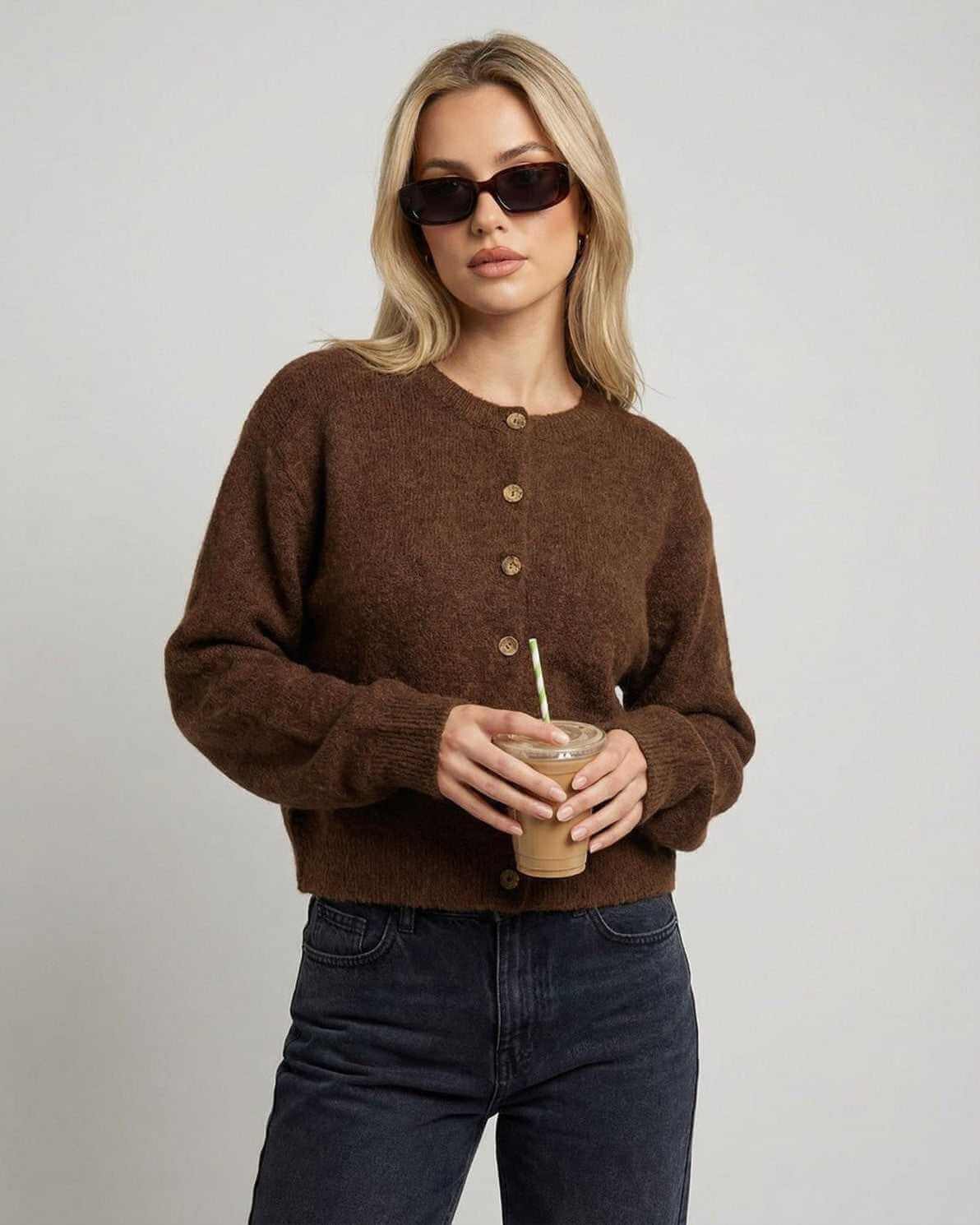 Cocoa Cardigan — Button-front knit cardigan in brown worn by a woman holding a drink, perfect for casual styling.