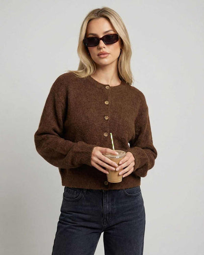 Cocoa Cardigan — Button-front knit cardigan in brown worn by a woman holding a drink, perfect for casual styling.