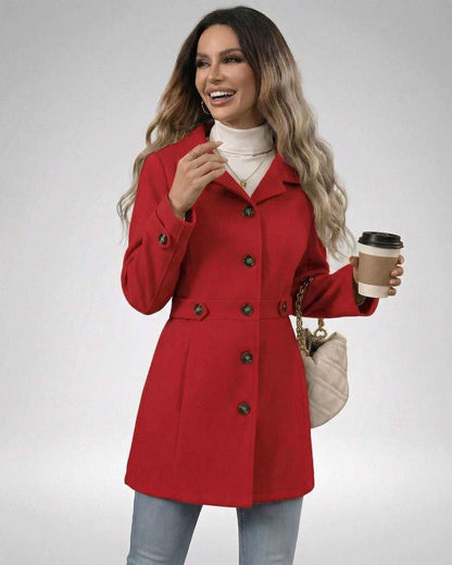 Woman wearing a Crimson Sculpt Jacket in red, showcasing its tailored fit and elegant design.