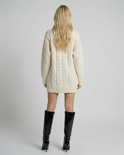 Back view of a model wearing the Eira Sweater by RAMBLION, featuring a cable-knit design and long sleeves.