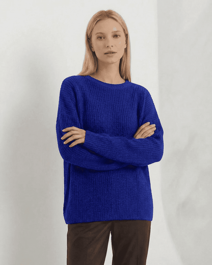 Indira Sweater in vibrant blue, showcasing loose fit and ribbed knit design, perfect for stylish winter wear.