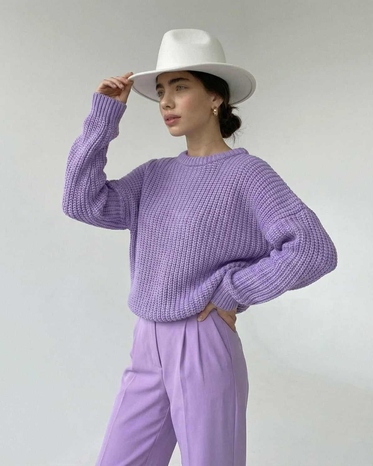 Lavande Sweater from RAMBLION in textured knit, featuring a relaxed fit and paired with stylish pastel pants.