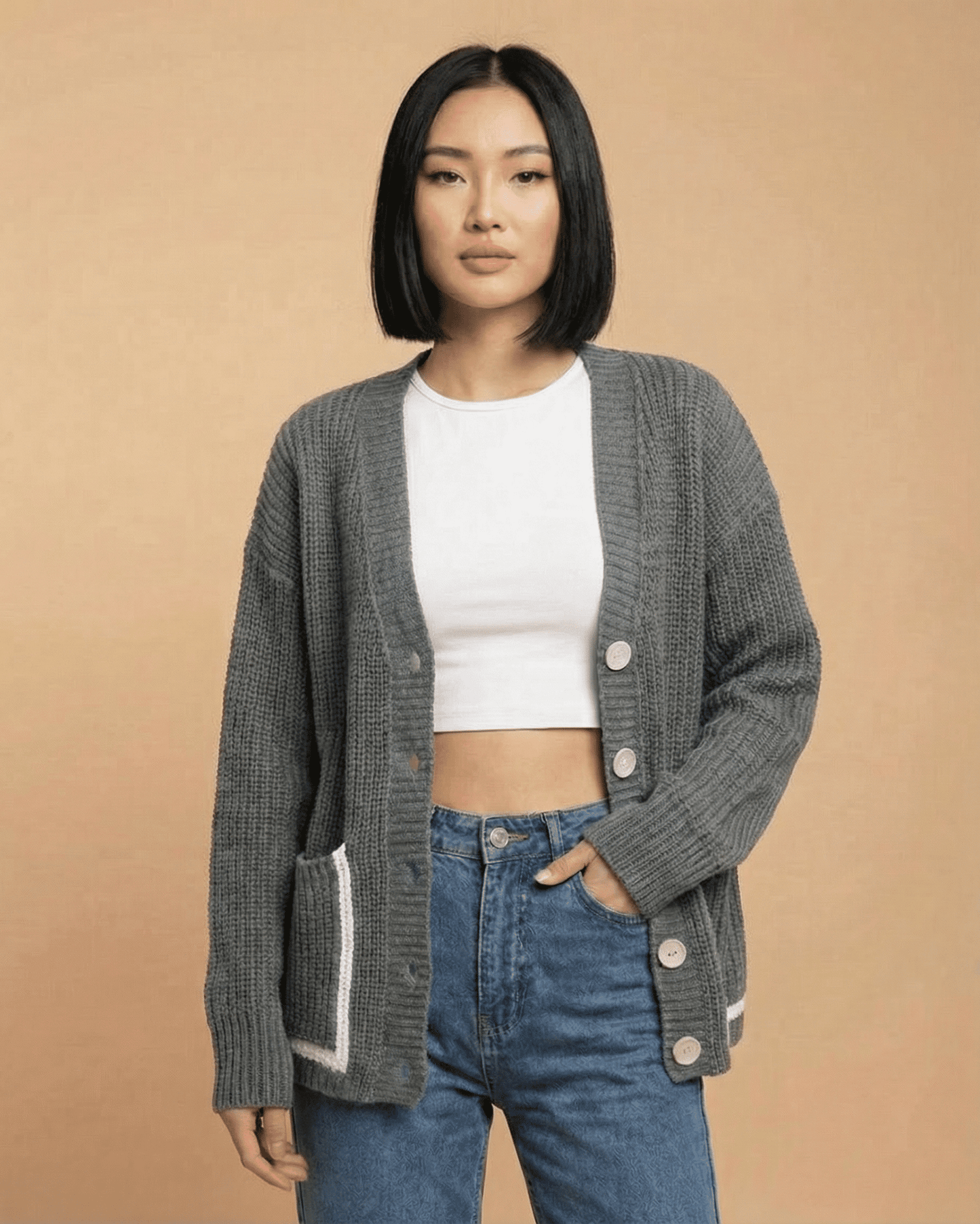 Linden Cardigan displayed on a model, featuring a relaxed V-neck, button-front closure, and color block design.