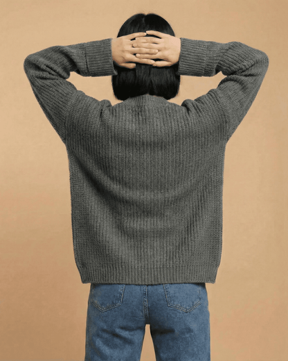 Back view of a model wearing the Linden Cardigan in gray, showcasing its relaxed fit and cozy design.