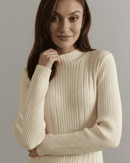 Model wearing a soft, ribbed knit top with long sleeves, showcasing the elegant style of the Luna Mini Dress.
