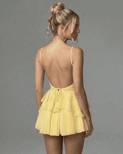 Marigold Mini Dress featuring a backless design with adjustable spaghetti straps and tiered ruffle skirt.