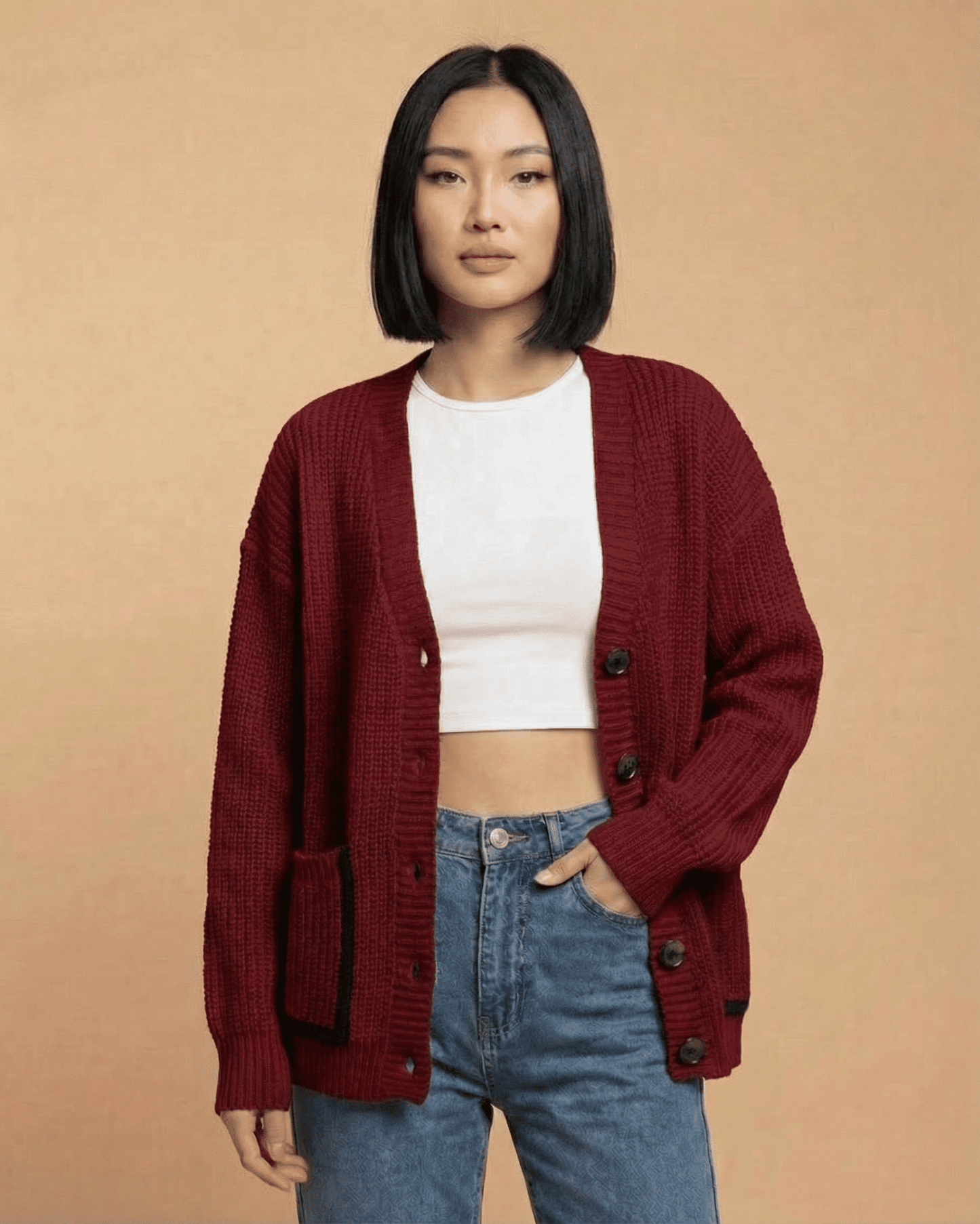 Model wearing Merano Cardigan by RAMBLION in burgundy color, styled with a white top and jeans.