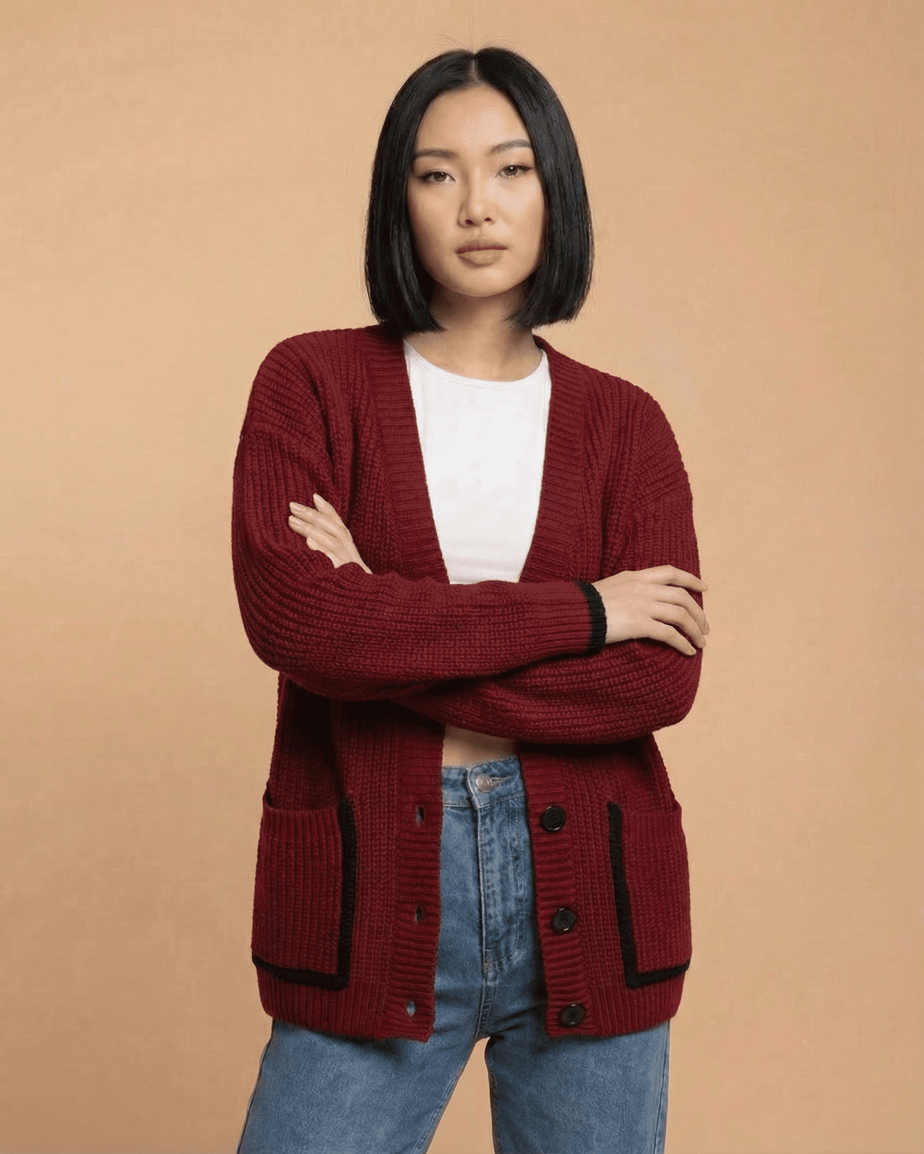 Model wearing the Merano Cardigan by RAMBLION in red, featuring a loose fit and button-front design.