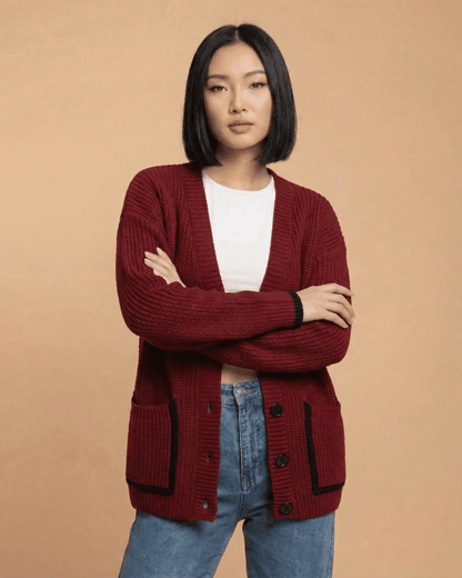 Model wearing the Merano Cardigan by RAMBLION in red, featuring a loose fit and button-front design.