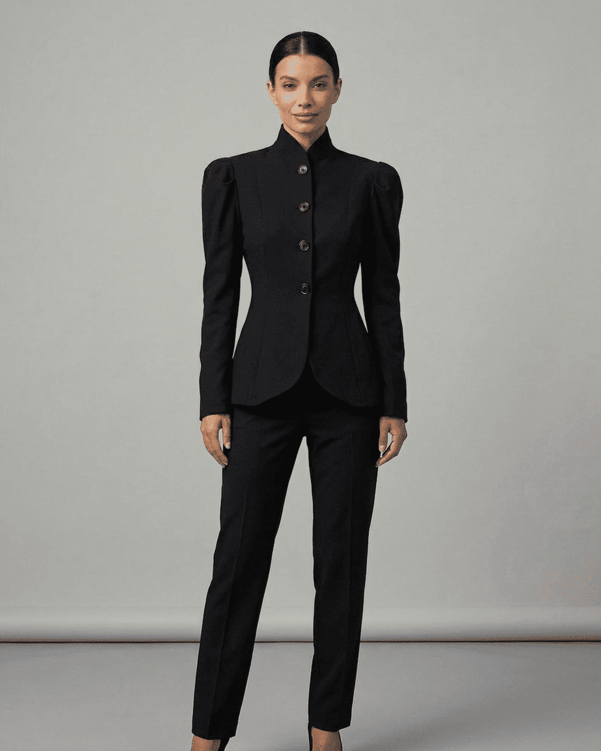 Elegant woman wearing Noiré Blazer with stand collar and puff sleeves, tailored for sophistication and formal occasions.