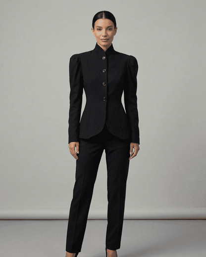 Elegant woman wearing Noiré Blazer with stand collar and puff sleeves, tailored for sophistication and formal occasions.