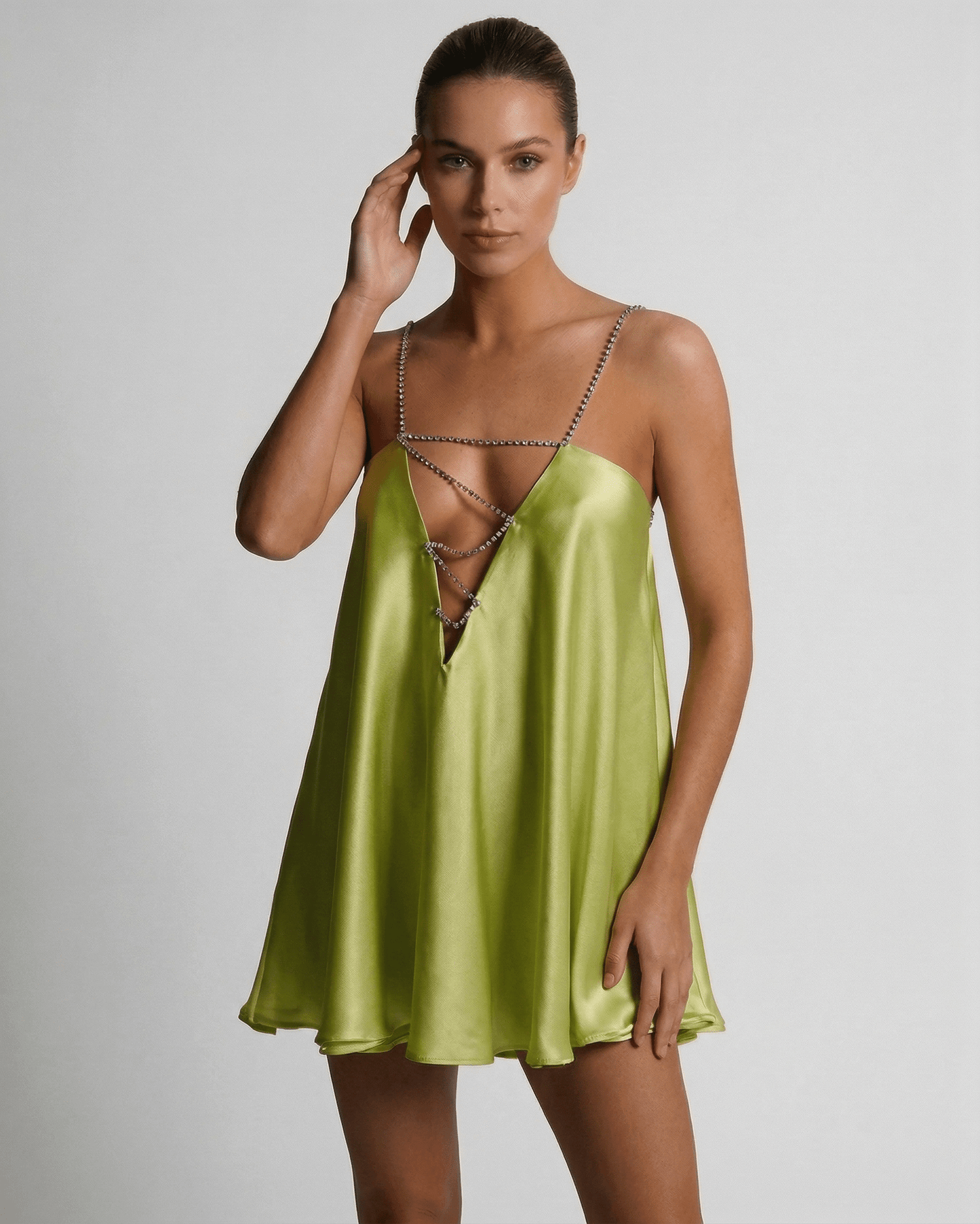 Nyra Mini Dress featuring a silky green hue and A-line silhouette, perfect for chic summer occasions by RAMBLION.