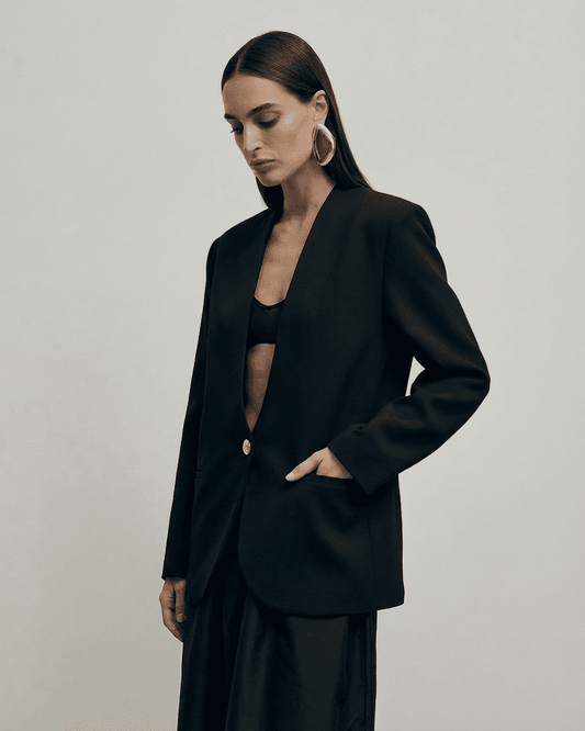 Obsidia Blazer worn by a model, featuring a minimalist design with deep V-neckline and structured shoulders.