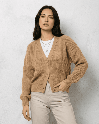Saffron Cardigan worn by a model featuring a relaxed V-neck and stylish beige knit.