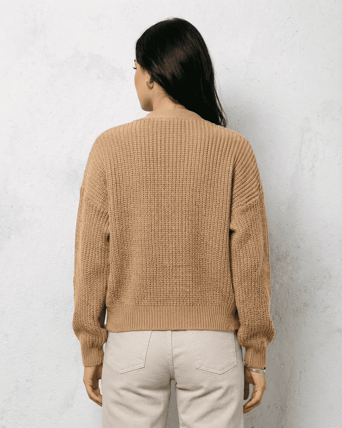 Back view of Saffron Cardigan in beige knitwear, featuring relaxed fit and ribbed cuffs, designed by RAMBLION.