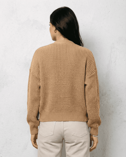 Back view of Saffron Cardigan in beige knitwear, featuring relaxed fit and ribbed cuffs, designed by RAMBLION.