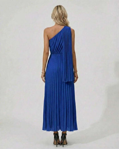 Back view of the Sapphire Midi Dress in blue with one shoulder and pleated hem, perfect for elegant evening wear.
