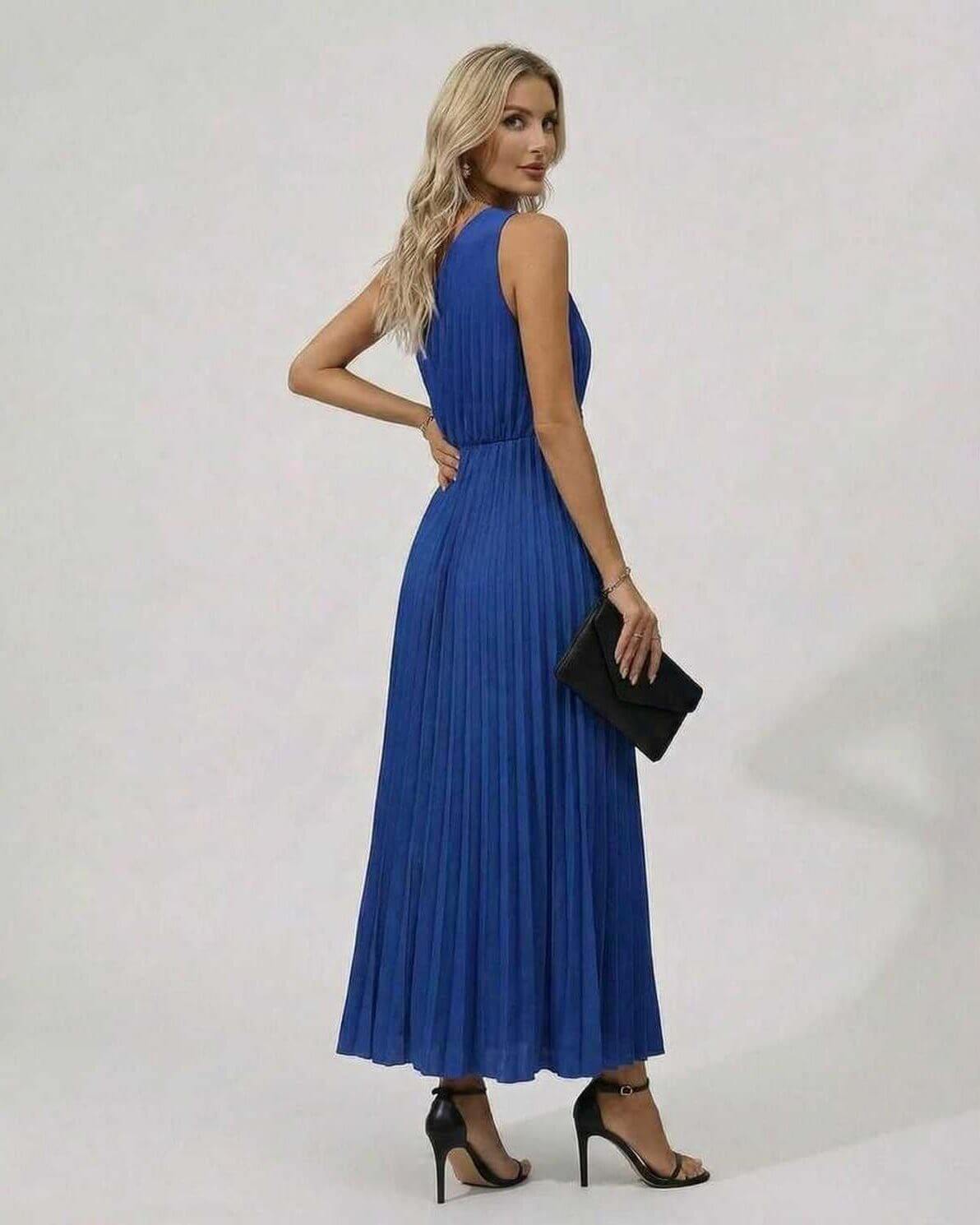 Model wearing the Sapphire Midi Dress in blue, showcasing the pleated hem and one-shoulder twist front design.
