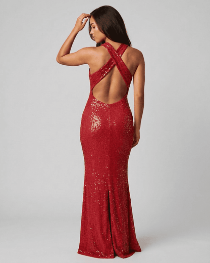 Back view of a woman wearing the RAMBLION Scarlet Maxi Dress, showcasing its backless V-neck design and sequined finish.