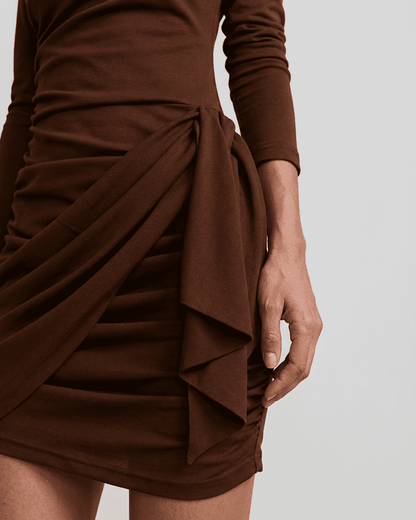 Sienna Mini Dress showing ruched detailing and stylish bow accent on a fitted bodycon silhouette.